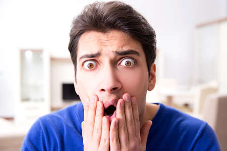 Man panicking because of pimples on the skinの写真素材