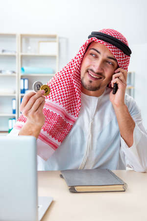 Arab man with bitcoin in cryptocurrency mining conceptの写真素材