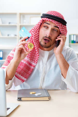 Arab man with bitcoin in cryptocurrency mining conceptの写真素材