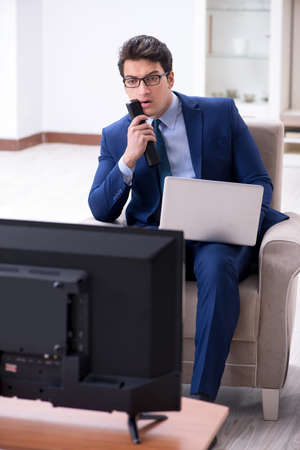 Businessman watching tv in the officeの写真素材