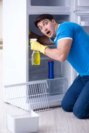 Man cleaning fridge in hygiene conceptの写真素材
