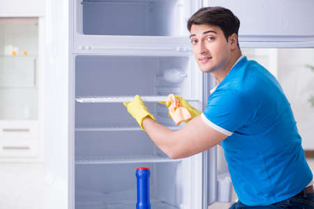 Man cleaning fridge in hygiene conceptの写真素材