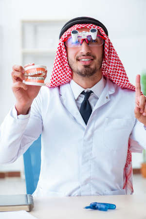 Arab dentist working on new teeth implantの写真素材