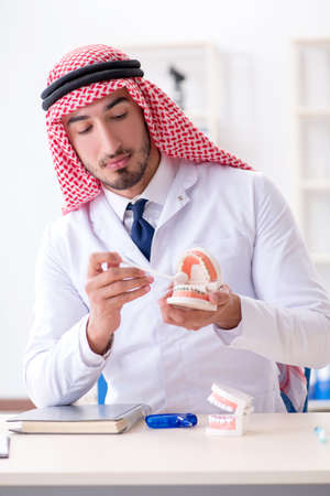 Arab dentist working on new teeth implantの写真素材