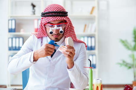 Arab dentist working on new teeth implantの写真素材