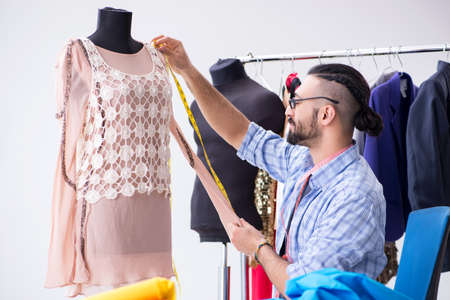 Male tailor working in the workshop on new designs