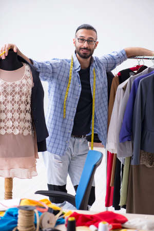 Male tailor working in the workshop on new designsの写真素材