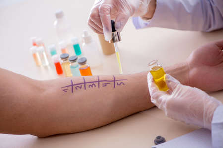 Doctor testing allergy reaction of patient in hospitalの写真素材