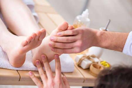 Foot massage in medical spaの写真素材