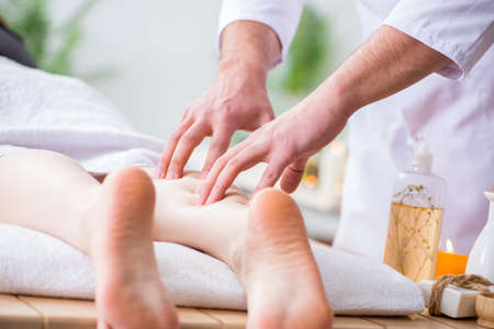 Foot massage in medical spaの写真素材