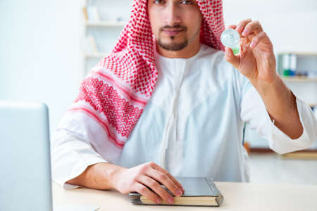 Arab man with bitcoin in cryptocurrency mining conceptの写真素材