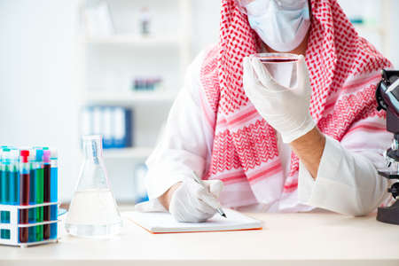 Arab doctor chemist studying new virus in labの写真素材