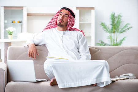 Arab man working at home on his workの写真素材