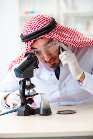 Arab chemist scientist testing quality of oil petrolの写真素材