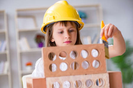 Young girl building with construction bricks