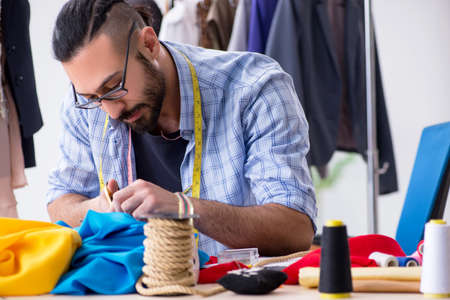 Male tailor working in the workshop on new designsの写真素材