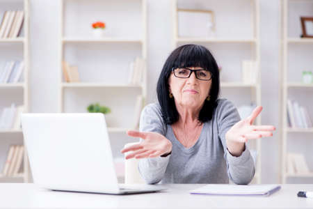 Senior woman struggling at computer
