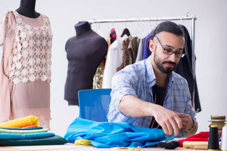 Male tailor working in the workshop on new designs