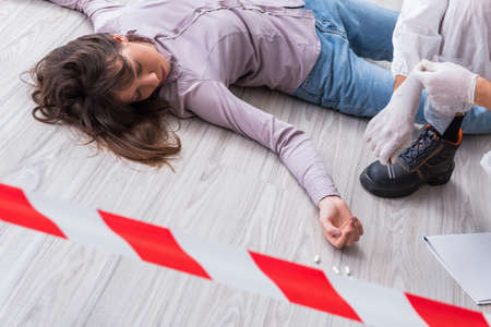 Forensic investigator at the crime scene investigating woman murの写真素材