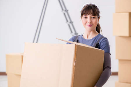Woman contractor moving boxes in relocation concept