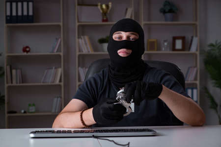 Hacker hacking computer late at nightの写真素材