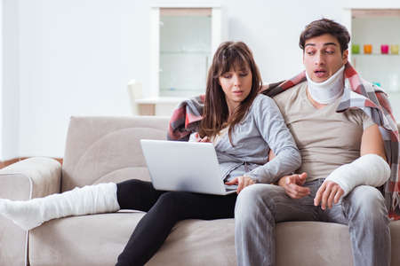 Injured family of wife and husband recovering at homeの写真素材