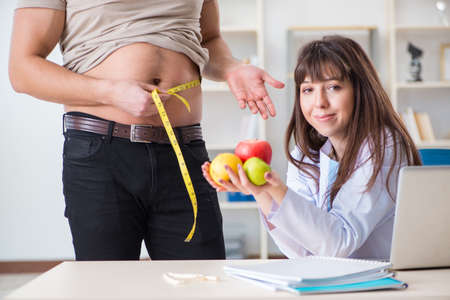 Doctor dietician giving advices to fat overweight patientの写真素材