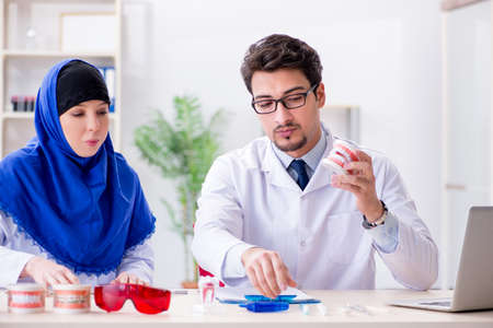 Dentist doctor and assistant working on new tooth implant