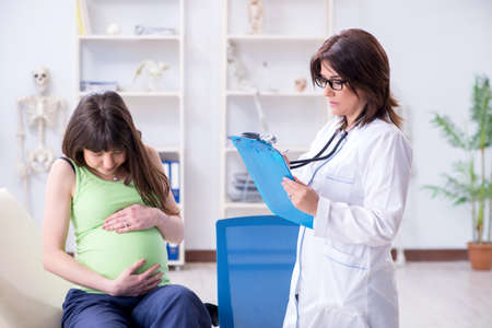 Pregnant woman visiting doctor for regular check-upの写真素材