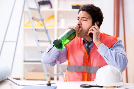 Drunk engineer working in the workshopの写真素材