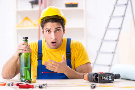 Drunk engineer working in the workshopの写真素材