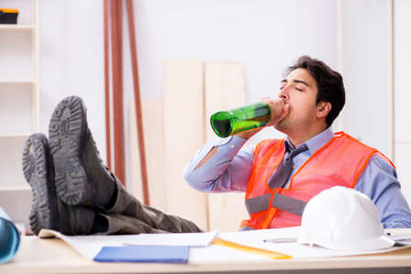 Drunk engineer working in the workshopの写真素材