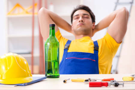 Drunk engineer working in the workshopの写真素材