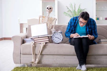 Student studying with skeleton preparing for examsの写真素材