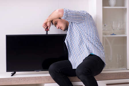 Man repairing broken tv at homeの写真素材