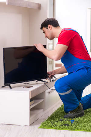 Professional repair engineer repairing broken tvの写真素材