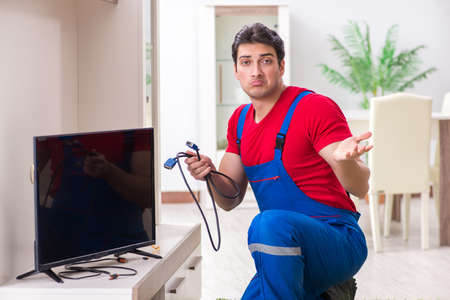 Professional repair engineer repairing broken tvの写真素材