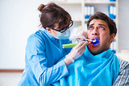 Patient afraid of dentist during doctor visitの写真素材