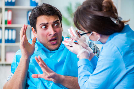 Patient afraid of dentist during doctor visitの写真素材