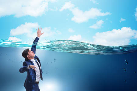 Drowning businessman in insolvency and bankruptcy conceptの写真素材