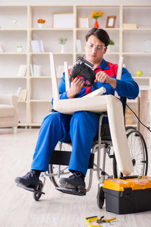 Disabled man repairing chair in workshop
