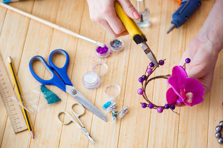 Woman making jewelry at homeの写真素材