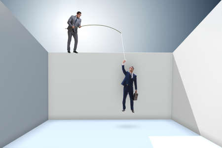 Businessman fishing his colleague in business conceptの写真素材