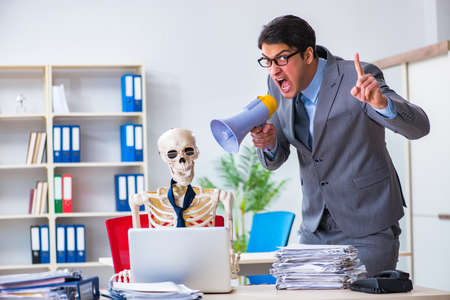 Angry boss yelling at his skeleton employeeの写真素材