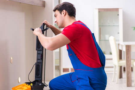 Professional repair engineer repairing broken tvの写真素材