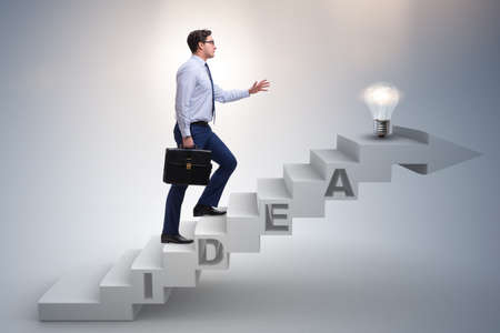 Concept of idea with businessman climbing steps stairsの写真素材