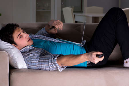 Man watching tv late at nightの写真素材