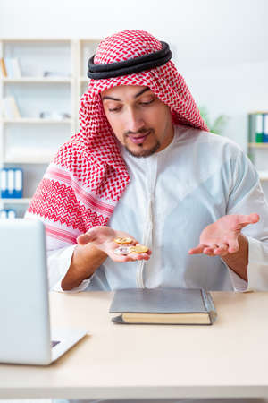 Arab man with bitcoin in cryptocurrency mining conceptの写真素材