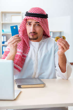 Arab man with bitcoin in cryptocurrency mining conceptの写真素材