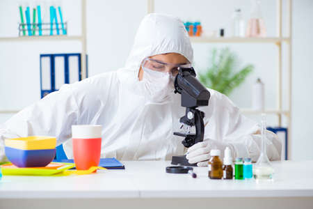 Chemist checking and testing plastic dishes